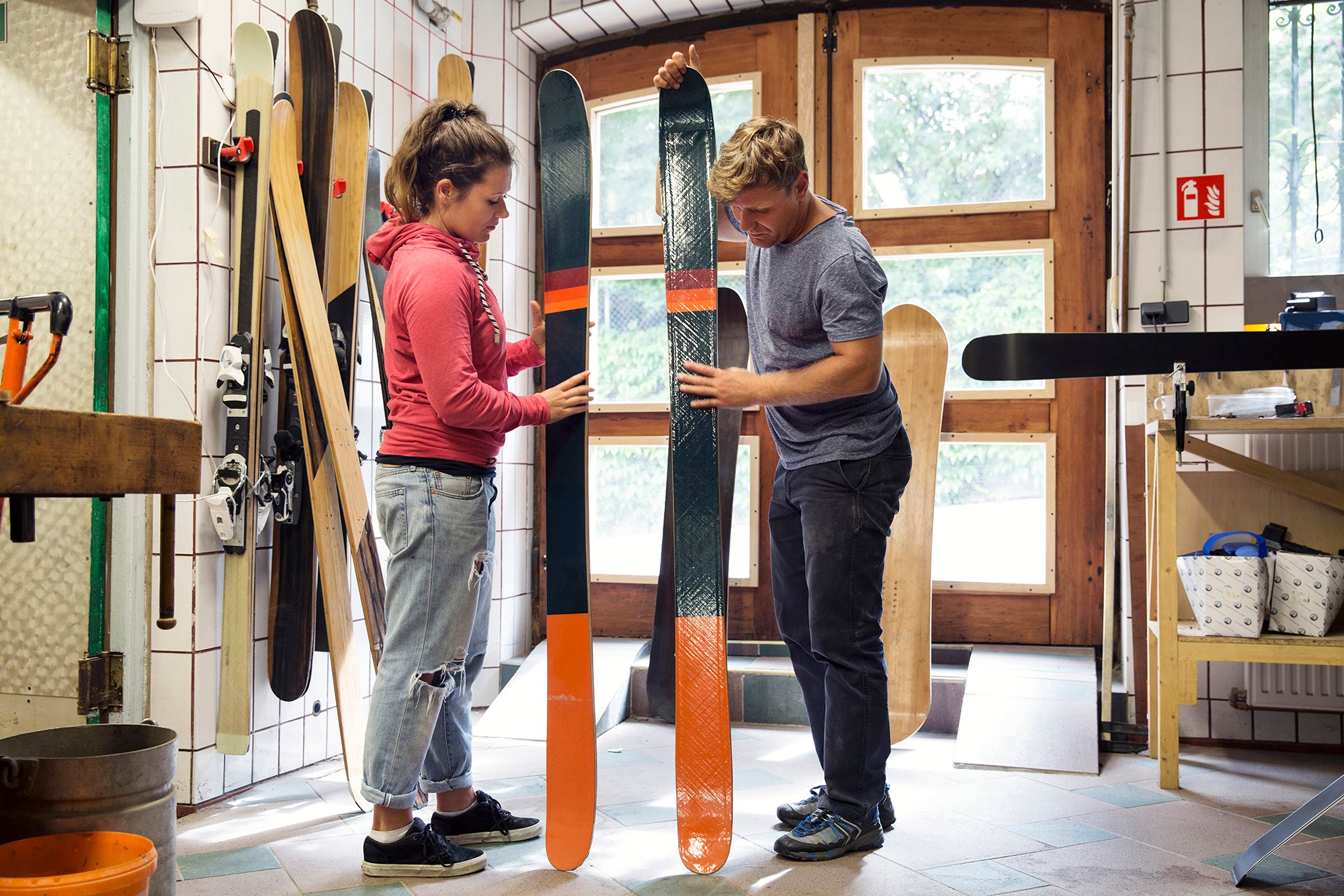man-and-woman-in-workshop-inspecting-ski-equipmen-2023-11-27-05-05-53-utc.jpg